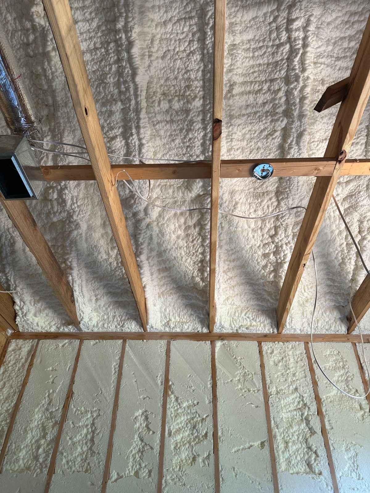Open-cell spray foam attic ceiling over ductwork and decking — Mississippi